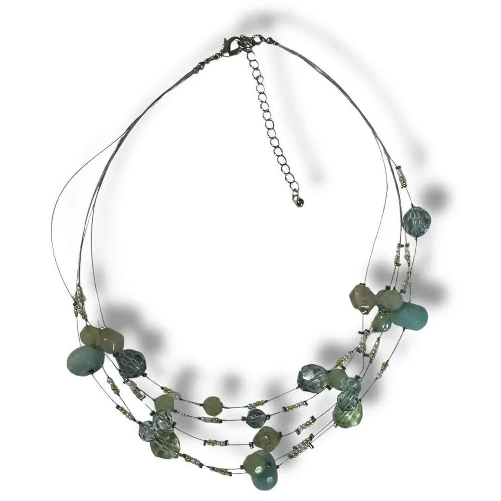 Silver tone wire necklace with pale green beads